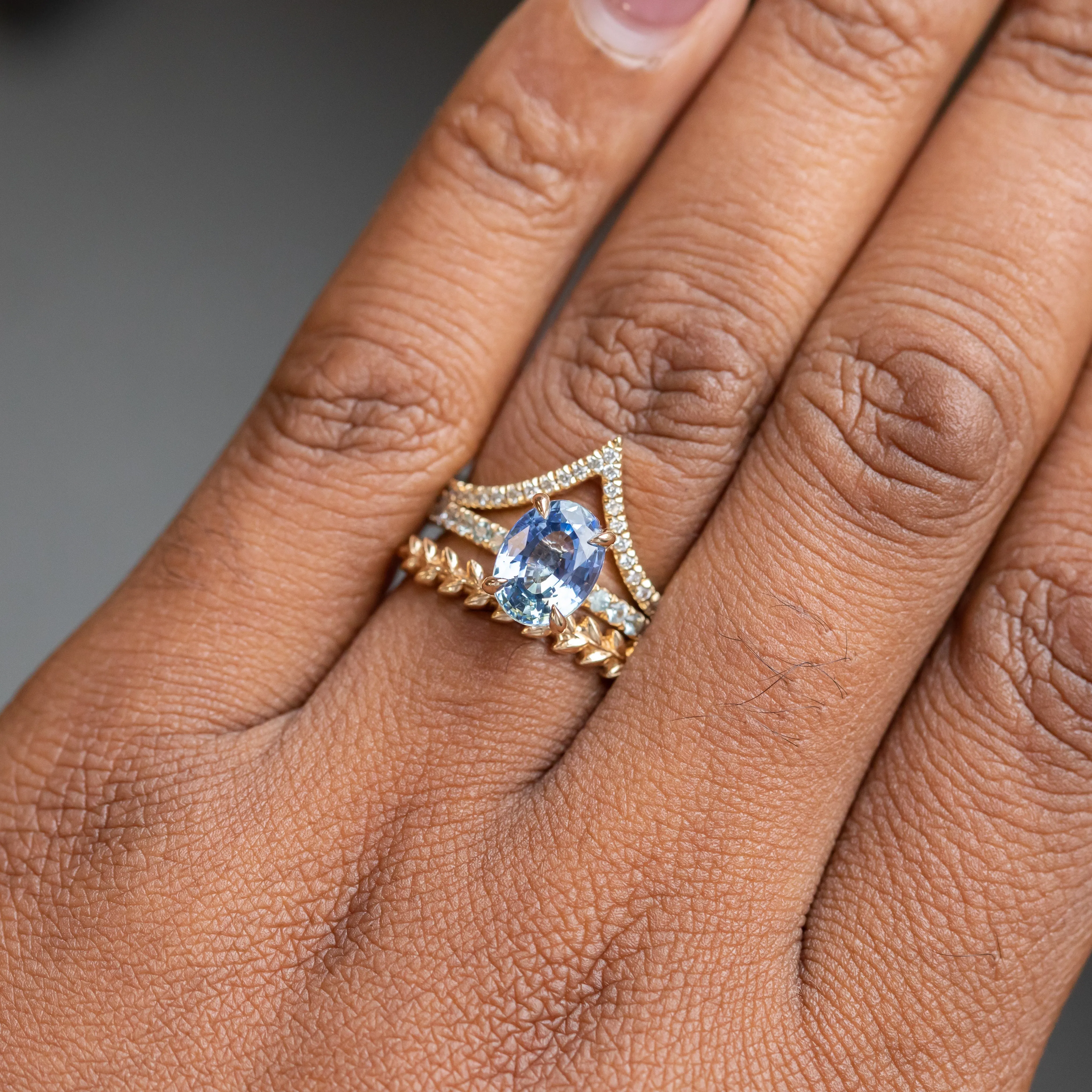 2.44ct Oval Madagascar Sapphire with French Set Montana Sapphires and Salt & Pepper Diamond Solitaire in 14k Yellow Gold